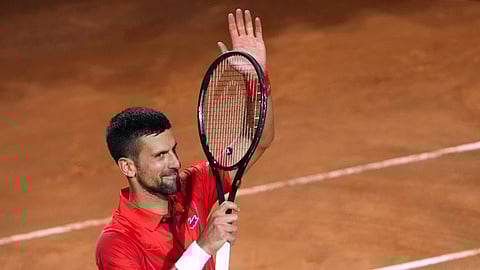 Djokovic hit on the head by water bottle