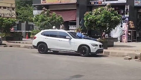 Teenage boy drives BMW car without license with man on bonnet