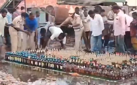 liquor lovers loot alcohol bottles during police destruction drive