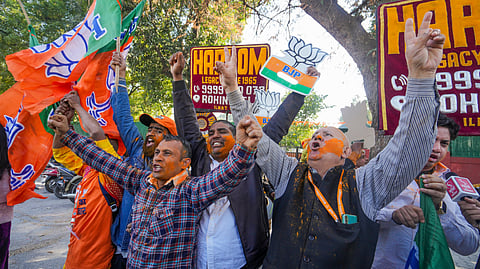 BJP supporters celebrate the party's lead in the Delhi Assembly polls