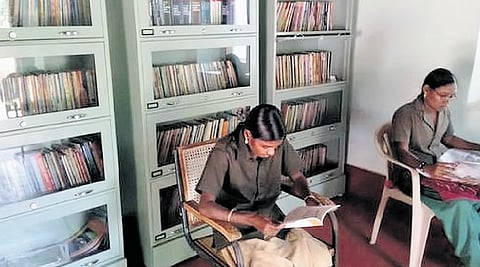 Tribal women of Chinnar Wildlife Sanctuary reading books at the Bodhi library