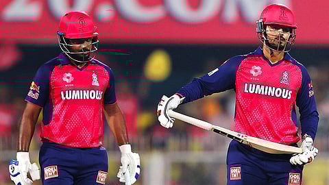 Nitish Rana celebrates his half-century. Sanju is nearby