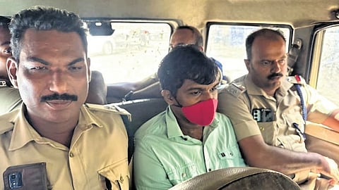 Police escort Cadell Jeanson Raja out of the Vanchiyoor court in Thiruvananthapuram