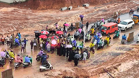 Locals protest on the Kuppath National Highway near Taliparamba