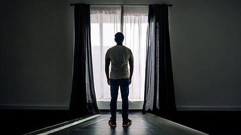 Thanatophobia, man standing infront of window