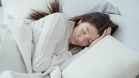 A Woman sleeps in a Bed