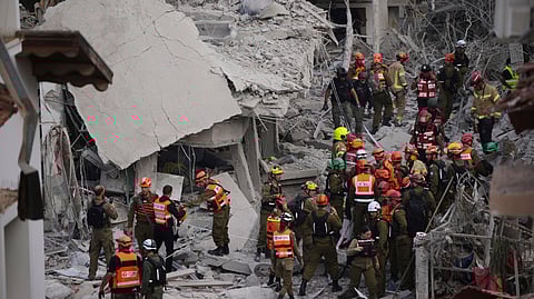 Israeli security forces inspect destroyed houses that were struck by a missile fired from Iran
