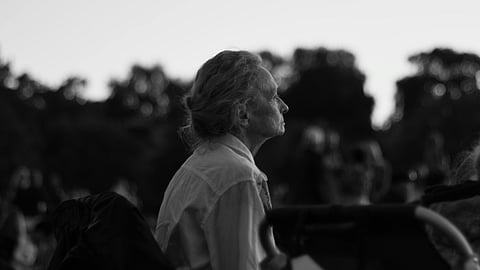 old woman sitting in a bench