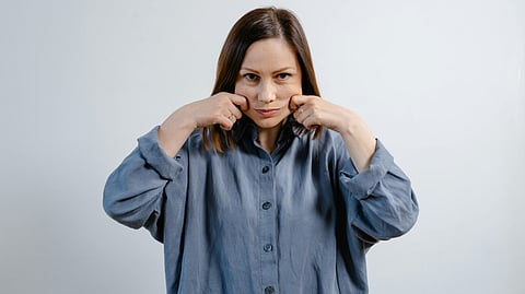 Woman doing Facial Massage on her Face