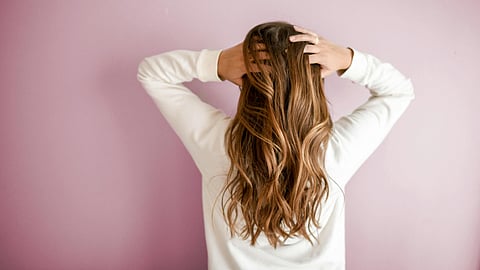 Woman combing hair with fingers