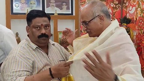 C Sadanandan Master is adorned with a Ponnada by his colleague