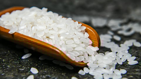 White Rice in Measuring Wooden Scoop