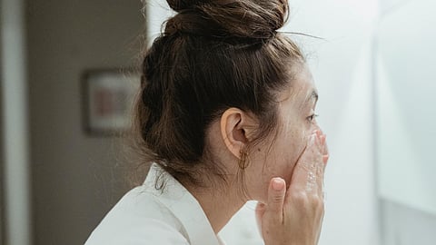 woman washing her face