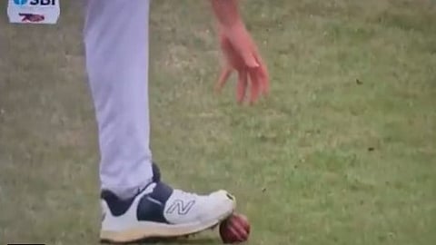 Brydon Carse kicks the ball with his shoe and stops it