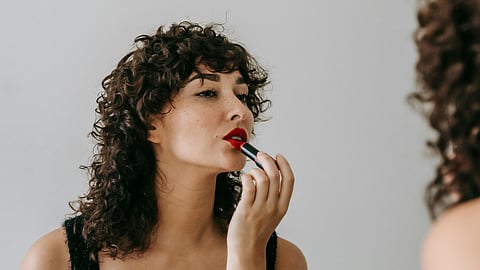 woman using lipstick