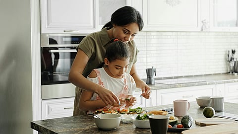 Mother and daughter cooking