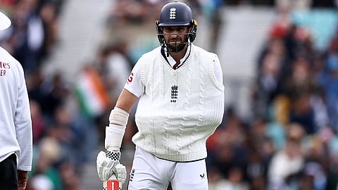 Chris Woakes, who comes out to bat with a sling over his shoulder