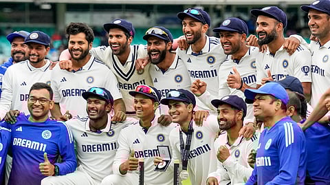 Indian team members pose for pictures following their victory in the fifth Test match against England