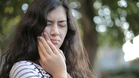 Woman having tooth pain