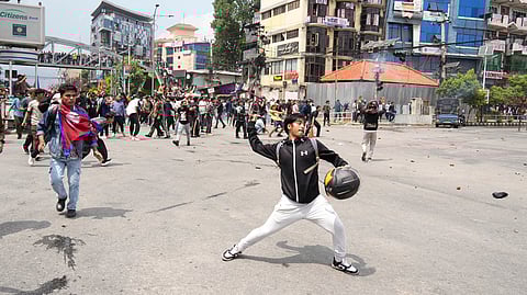 Protestors clash with the riot police outside the Parliament building in Kathmandu