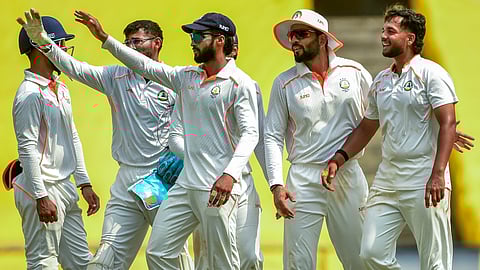 Vidarbha's Harsh Dubey celebrates with teammates after taking the wicket of Rest of India's Ishan Kishan