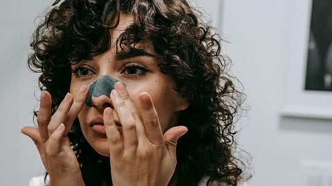 woman removing black heads