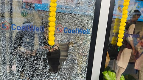 The glass of the AC bus shelter is broken