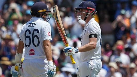 England's Harry Brook is congratulated by teammate Joe Root