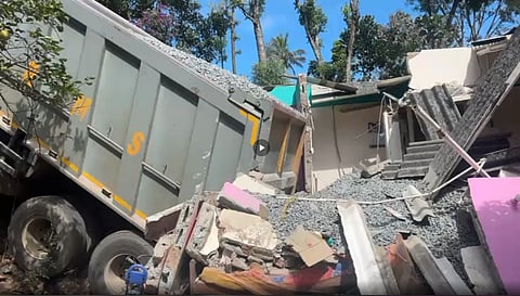 Accident in Nedumkandam as Tipper lorry overturns onto a house