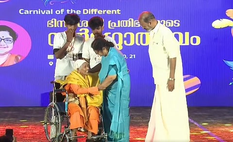 R. Bindu fulfills the singing aspirations of an elderly woman at a special function