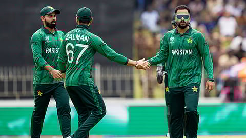 Pakistan's Mohammad Nawaz, right, celebrates with teammates the wicket of Netherlands' Bas de Leede