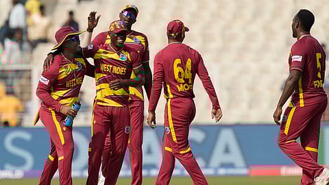 West Indies' Matthew Forde, right, celebrates the wicket of Italy's Gian Piero Meade during the T20 World Cup cricket match