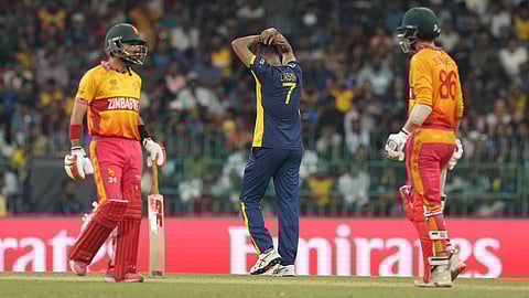 Sri Lanka's captain Dasun Shanaka, center, reacts as Zimbabwe's captain Sikandar Raza, left, and Brian Bennett score runs during the T20 World Cup cricket match