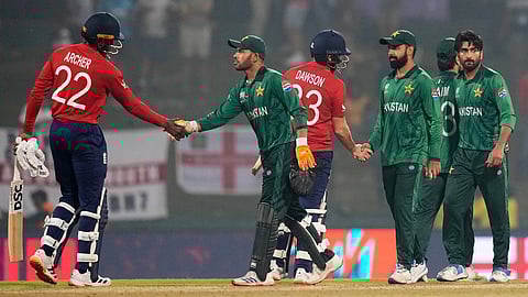 England's Jofra Archer, left, and Liam Dawson shake hands after winning the T20 World Cup cricket match