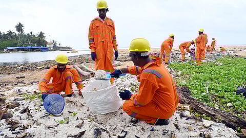 Image of Sanitation workers remove plastic waste
