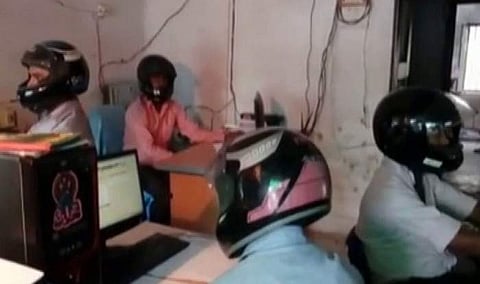 ഓഫിസില് ഹെല്മെറ്റ് ധരിച്ച് സര്ക്കാര് ഉദ്യോഗസ്ഥര്; ഇല്ലേല് ജീവന് പോകും