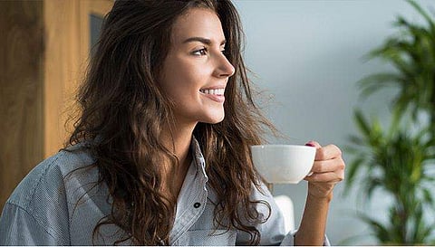 image of a woman enjoying a cup of coffee