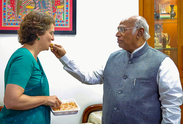 Priyanka Gandhi Vadra being offered sweets by party President Mallikarjun Kharge