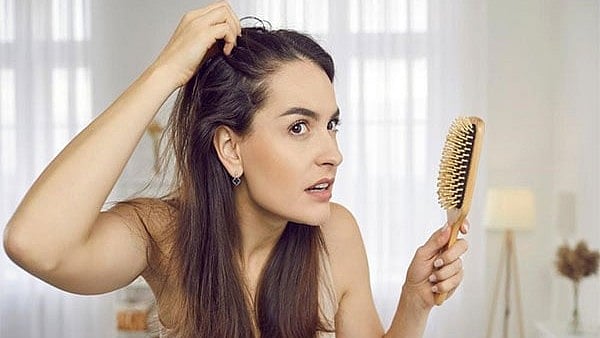 Woman combing hair
