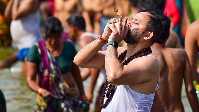 ത്രിവേണി സംഗമത്തിൽ പുണ്യസ്നാന സമയത്ത് ഒരു ഭക്തൻ ശംഖ് ഊതുന്നു