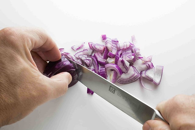chopping onion for salad summer season