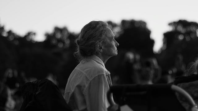 old woman sitting in a bench
