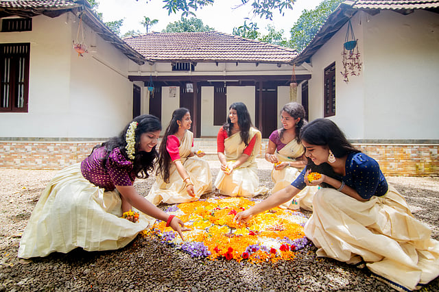 women making pookkalam