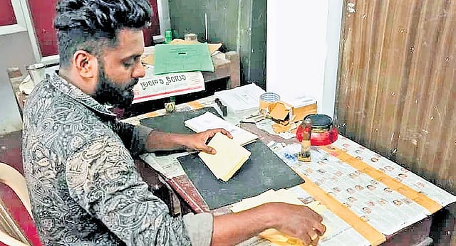 Postman Vishnu engaged in work at the Sabarimala post office