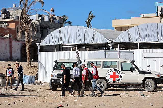 Red Crescent vehicles and refrigerated trucks, transporting the bodies of 45 Palestinians that had been in Israeli custody
