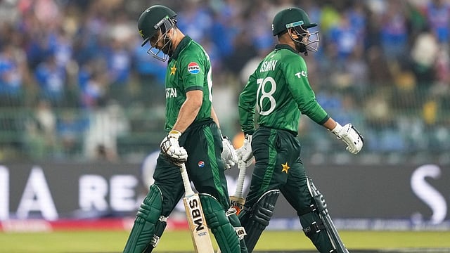 Pakistan's captain Salman Ali Agha, left, leaves the ground after losing his wicket as teammate Usman Khan walks in during the T20 World Cup cricket match