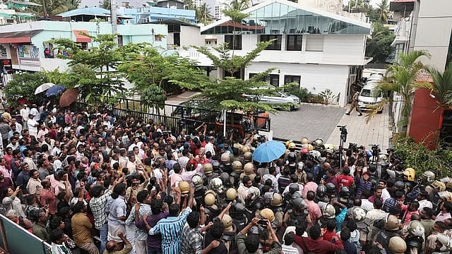 CPM workers gather in large numbers outside the residence of Opposition Leader Pinarayi Vijayan near Bakery Junction in Thiruvananthapuram on Wednesday.