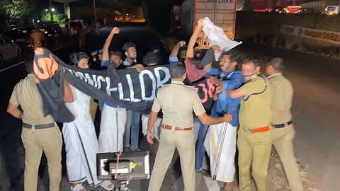 എസ്എഫ്‌ഐ പ്രവര്‍ത്തകര്‍ കരിങ്കൊടി കാണിക്കുന്നു
