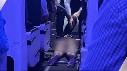 Australian police arrest a man accused of running naked through an airliner
