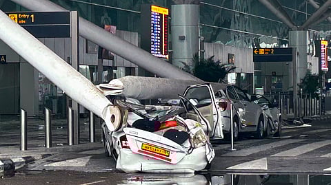 Parked vehicles damaged by the collapse of a canopy at the Terminal 1 of Indira Gandhi International Airport amid heavy rain